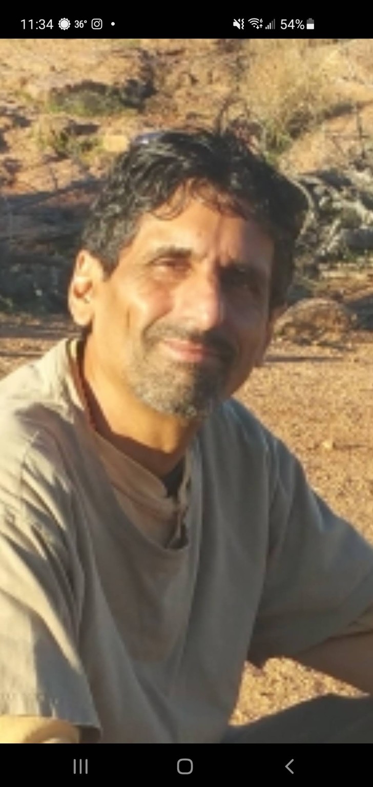 Raju Bhatt seated outdoors in warm sunlight